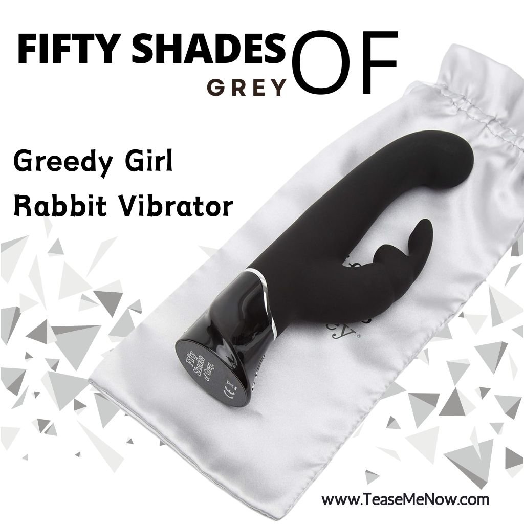 An advertisement for the 'Fifty Shades of Grey Greedy Girl Rabbit Vibrator.' The image showcases a sleek black rabbit vibrator placed on a silky grey drawstring bag. The branding 'Fifty Shades of Grey' is prominently displayed at the top, and the product is labeled as the 'Greedy Girl Rabbit Vibrator.' The design features elegant curves with dual stimulation arms, creating a luxurious and sophisticated aesthetic. The background features a geometric grey triangle pattern