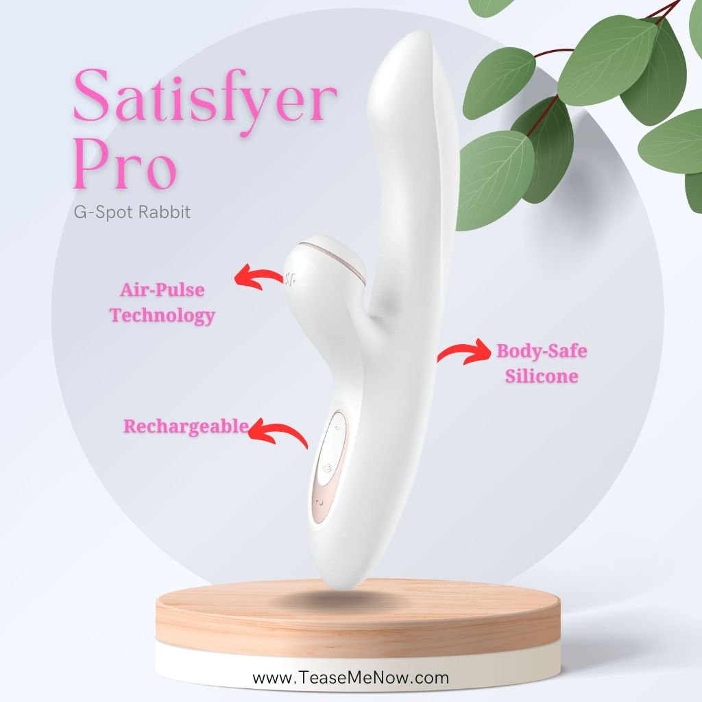 An advertisement for the 'Satisfyer Pro G-Spot Rabbit' in white. The sleek and ergonomic design is prominently displayed on a wooden pedestal with text highlighting key features: 'Air-Pulse Technology,' 'Rechargeable,' and 'Body-Safe Silicone.' The product has soft curves and a modern aesthetic, with green leaves subtly accenting the background. The website 'TeaseMeNow.com' is visible at the bottom.